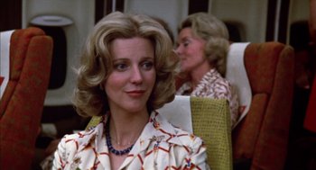 Movie still from “Futureworld” (1976), directed by Richard T. Heffron – Two women sitting in a chair with one of them wearing a necklace; Close Up shot, Low angle