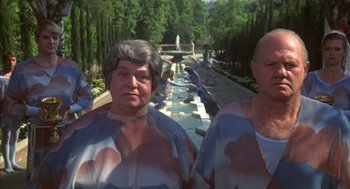 Movie still from “Futureworld” (1976), directed by Richard T. Heffron – A group of people standing next to each other in front of a fountain; Medium shot, High angle