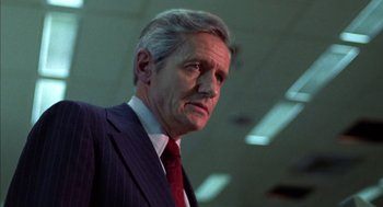 Movie still from “Futureworld” (1976), directed by Richard T. Heffron – An older man wearing a suit and tie; Close Up shot, Low angle