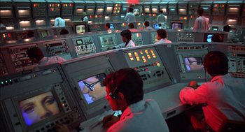 Movie still from “Futureworld” (1976), directed by Richard T. Heffron – A group of people in a control room; Wide shot, High angle