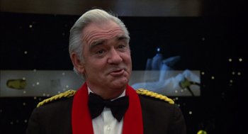 Movie still from “Futureworld” (1976), directed by Richard T. Heffron – An older man in a military uniform and a bow tie; Close Up shot, Low angle