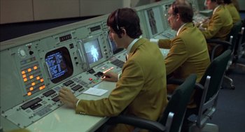 Movie still from “Futureworld” (1976), directed by Richard T. Heffron – Two men are working in a control room; Medium shot, High angle