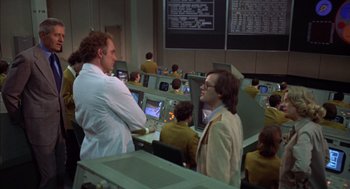Movie still from “Futureworld” (1976), directed by Richard T. Heffron – Two men in lab coats are looking at computer screens; Medium shot, Over the shoulder angle