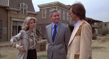 Movie still from “Futureworld” (1976), directed by Richard T. Heffron – Two men and a woman standing in front of a building; Medium shot, Over the shoulder angle