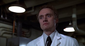 Movie still from “Futureworld” (1976), directed by Richard T. Heffron – A man in a white lab coat and a tie; Close Up shot, Low angle