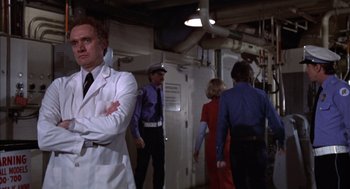 Movie still from “Futureworld” (1976), directed by Richard T. Heffron – A group of people standing around in a room; Medium shot, Low angle