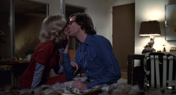 Movie still from “Futureworld” (1976), directed by Richard T. Heffron – A man and a woman are kissing on a table; Medium shot, Over the shoulder angle
