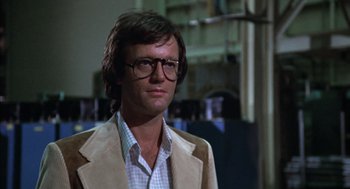 Movie still from “Futureworld” (1976), directed by Richard T. Heffron – A person wearing glasses and a jacket; Close Up shot, Low angle