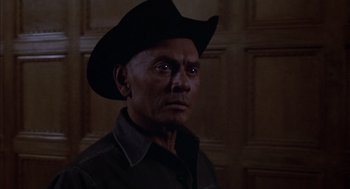 Movie still from “Futureworld” (1976), directed by Richard T. Heffron – A man wearing a cowboy hat in front of a wooden wall; Close Up shot, Low angle