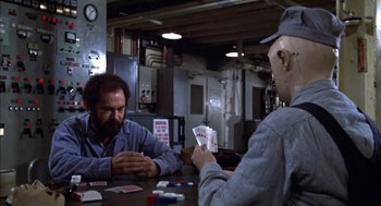 Movie still from “Futureworld” (1976), directed by Richard T. Heffron – Two men sitting at a table playing cards; Medium shot, Over the shoulder angle