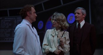 Movie still from “Futureworld” (1976), directed by Richard T. Heffron – A group of people standing next to each other on a stage; Medium shot, Low angle