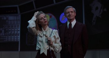 Movie still from “Futureworld” (1976), directed by Richard T. Heffron – A man and a woman standing next to each other; Medium shot, Low angle