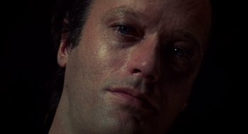 Movie still from “Futureworld” (1976), directed by Richard T. Heffron – A man's face in a dimly - lit room; Extreme Close Up shot, Overhead angle