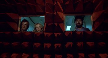 Movie still from “Futureworld” (1976), directed by Richard T. Heffron – A group of people looking out of a window; Wide shot, Low angle