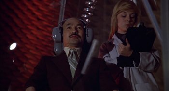 Movie still from “Futureworld” (1976), directed by Richard T. Heffron – A man and a woman wearing headphones in a room; Medium shot, Low angle