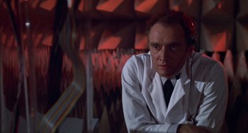 Movie still from “Futureworld” (1976), directed by Richard T. Heffron – A man wearing a lab coat and a tie; Medium shot, Low angle