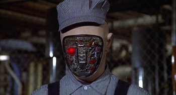 Movie still from “Futureworld” (1976), directed by Richard T. Heffron – A man wearing a hat and a face mask; Close Up shot, Low angle