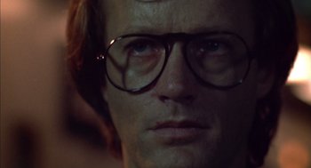 Movie still from “Futureworld” (1976), directed by Richard T. Heffron – A person wearing glasses; Close Up shot, Low angle