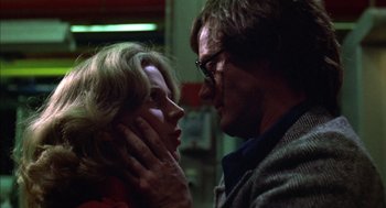 Movie still from “Futureworld” (1976), directed by Richard T. Heffron – A man and a woman face to face in a dark room; Close Up shot, Low angle