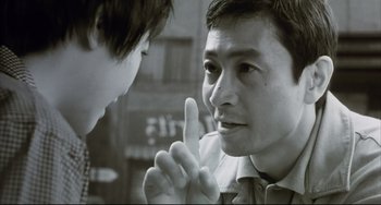 Movie still from “Gamera 3: Revenge of Iris” (1999), directed by Shûsuke Kaneko – A man and a boy talking to each other; Close Up shot, Over the shoulder angle