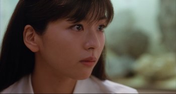 Movie still from “Gamera 3: Revenge of Iris” (1999), directed by Shûsuke Kaneko – A person looking at the camera; Close Up shot, Over the shoulder angle