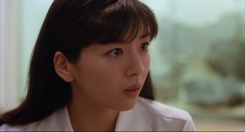 Movie still from “Gamera 3: Revenge of Iris” (1999), directed by Shûsuke Kaneko – A person wearing a white shirt; Close Up shot, Over the shoulder angle