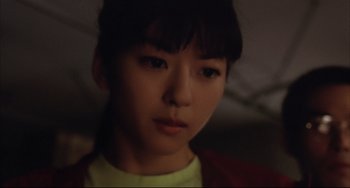 Movie still from “Gamera 3: Revenge of Iris” (1999), directed by Shûsuke Kaneko – A young asian girl is looking at the camera; Close Up shot, Low angle