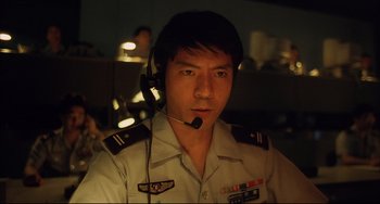 Movie still from “Gamera 3: Revenge of Iris” (1999), directed by Shûsuke Kaneko – A man in a uniform is wearing a headset; Close Up shot, Low angle