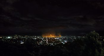 Movie still from “Gamera 3: Revenge of Iris” (1999), directed by Shûsuke Kaneko – A view of a city at night from a hill; Extreme Wide shot, High angle