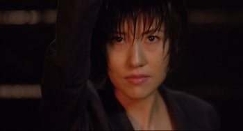 Movie still from “Gamera 3: Revenge of Iris” (1999), directed by Shûsuke Kaneko – A person with a hood over their head; Close Up shot, Low angle