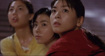 Movie still from “Gamera 3: Revenge of Iris” (1999), directed by Shûsuke Kaneko – A group of young women standing next to each other; Close Up shot, Low angle