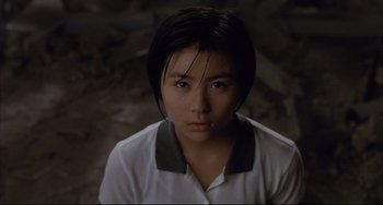 Movie still from “Gamera 3: Revenge of Iris” (1999), directed by Shûsuke Kaneko – A young woman with short black hair wearing a white shirt; Close Up shot, High angle