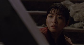 Movie still from “Gamera 3: Revenge of Iris” (1999), directed by Shûsuke Kaneko – A person looking at the camera; Close Up shot, Low angle