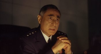 Movie still from “Gamera 3: Revenge of Iris” (1999), directed by Shûsuke Kaneko – A person wearing a uniform; Close Up shot, Low angle