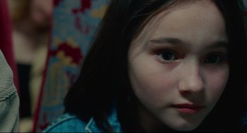 Movie still from “Aftersun” (2022), directed by Charlotte Wells – A young girl's face; Close Up shot, High angle