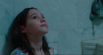 Movie still from “Aftersun” (2022), directed by Charlotte Wells – A young girl looking up into the sky; Close Up shot, Low angle