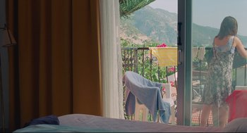 Movie still from “Aftersun” (2022), directed by Charlotte Wells – A view of a mountain from an open window; Wide shot, High angle