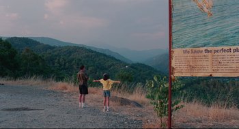 Movie still from “Aftersun” (2022), directed by Charlotte Wells – A man and a child standing on top of a hill; Extreme Wide shot, High angle