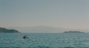Movie still from “Aftersun” (2022), directed by Charlotte Wells – Two people in a boat in the middle of the ocean; Extreme Wide shot, High angle