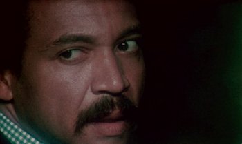 Movie still from “Ganja & Hess” (1973), directed by Bill Gunn – A person with a mustache; Close Up shot, Low angle