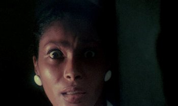 Movie still from “Ganja & Hess” (1973), directed by Bill Gunn – A person's face with a surprised look on their face; Extreme Close Up shot, Low angle