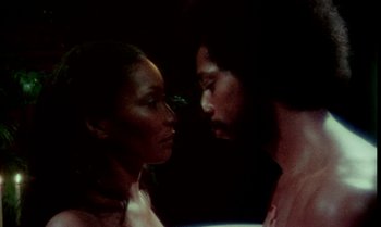 Movie still from “Ganja & Hess” (1973), directed by Bill Gunn – A man and a woman face to face in the dark; Close Up shot, Low angle