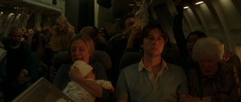 Movie still from “Garden State” (2004), directed by Zach Braff – A man and a woman on a plane with a baby; Medium shot, Low angle