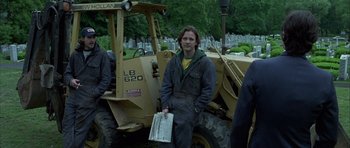 Movie still from “Garden State” (2004), directed by Zach Braff – A man standing in front of a large construction vehicle; Medium shot, Low angle