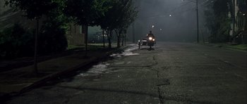 Movie still from “Garden State” (2004), directed by Zach Braff – A person riding a motorcycle down a street at night; Extreme Wide shot, High angle