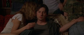Movie still from “Garden State” (2004), directed by Zach Braff – A young man sitting in front of a group of people; Medium shot, Over the shoulder angle