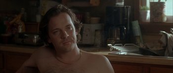 Movie still from “Garden State” (2004), directed by Zach Braff – A man with a beard is sitting in a kitchen; Close Up shot, Over the shoulder angle