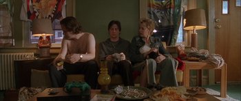 Movie still from “Garden State” (2004), directed by Zach Braff – A group of people sitting around a table with food on top of it; Medium shot, High angle