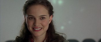 Movie still from “Garden State” (2004), directed by Zach Braff – A person smiling for the camera; Close Up shot, Over the shoulder angle