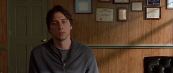 Movie still from “Garden State” (2004), directed by Zach Braff – A man standing in front of a wooden wall; Close Up shot, Low angle